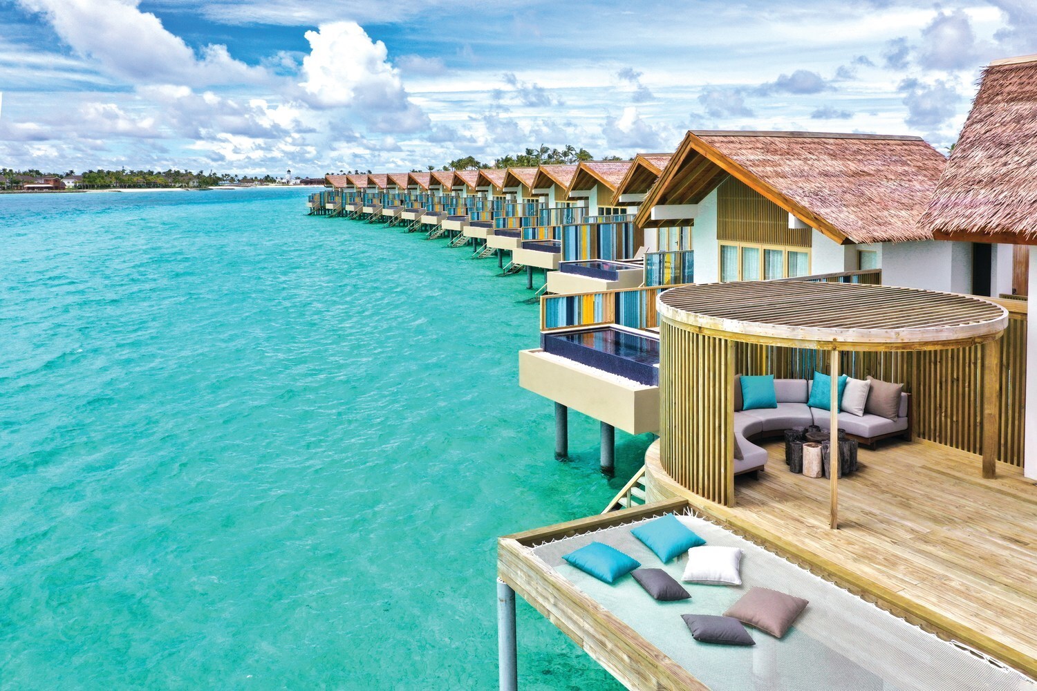 Cabanas sitting just above the water at Hard Rock Hotel Maldives 